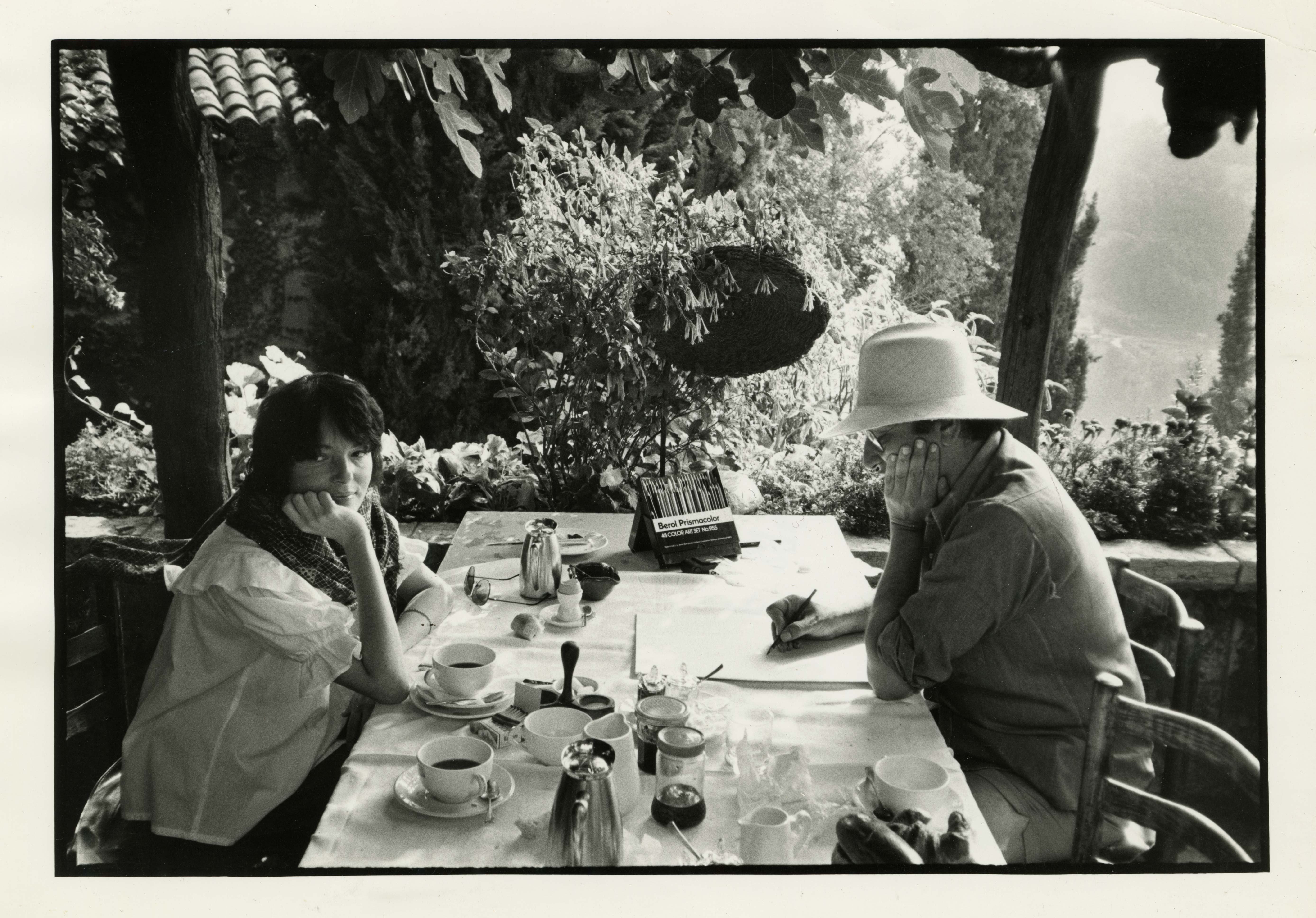 man and woman at a table in a garden